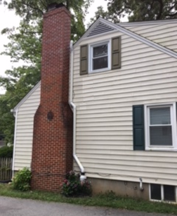 Exterior pipe and fan matching the contour of the chimney